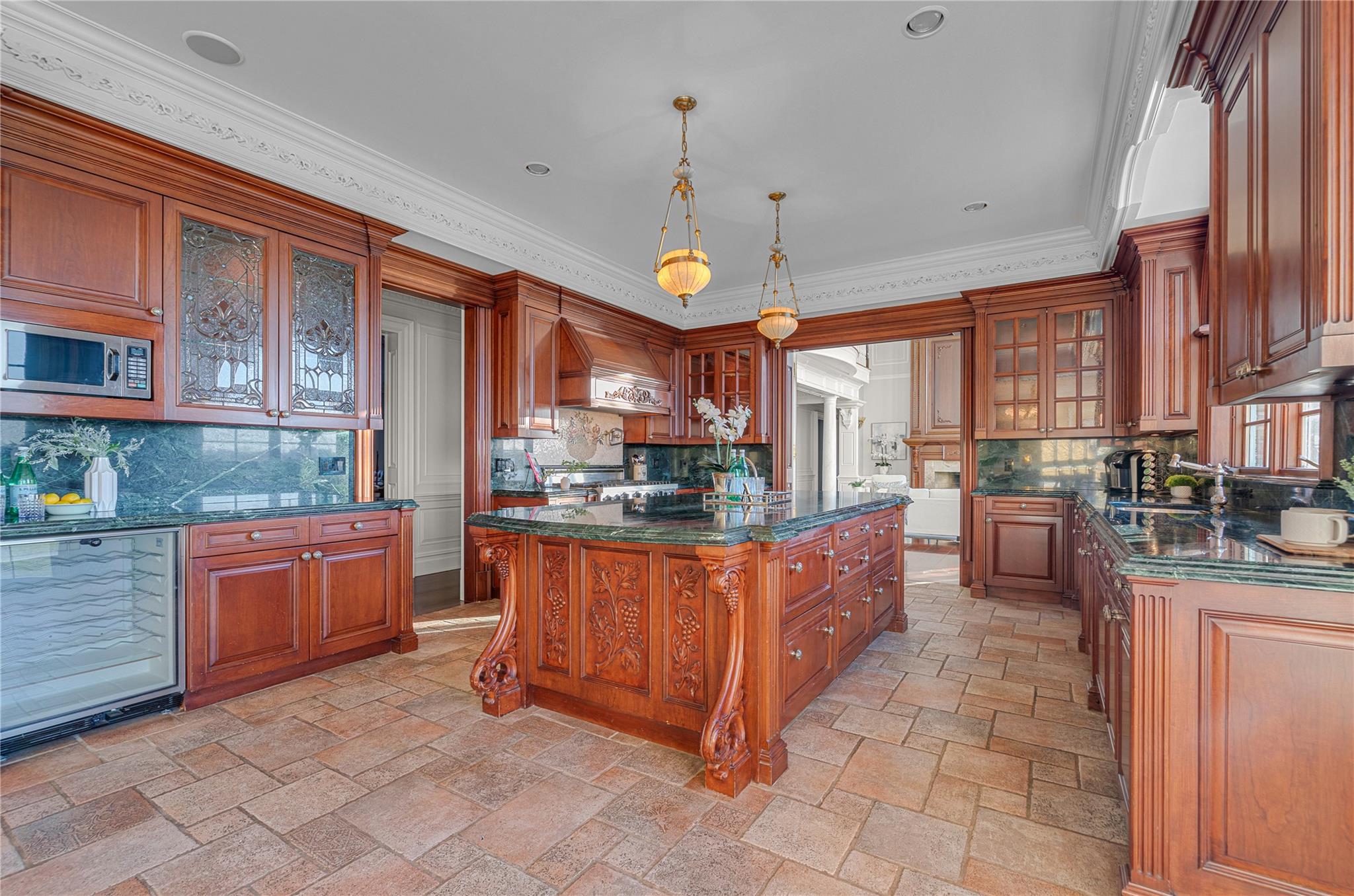 3 Point Crescent Queens, NY 11357 - Photo 15 of 38 Kitchen with stainless steel microwave, premium range hood, decorative backsplash, stone tile floors, and crown molding