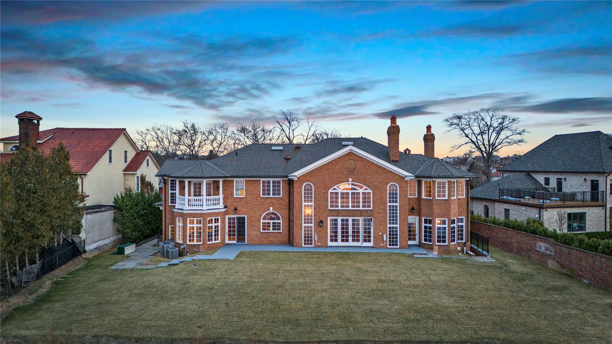 3 Point Crescent Queens, NY 11357 - Photo 33 of 38 Back of house at dusk with french doors, a patio, a balcony, and cooling unit