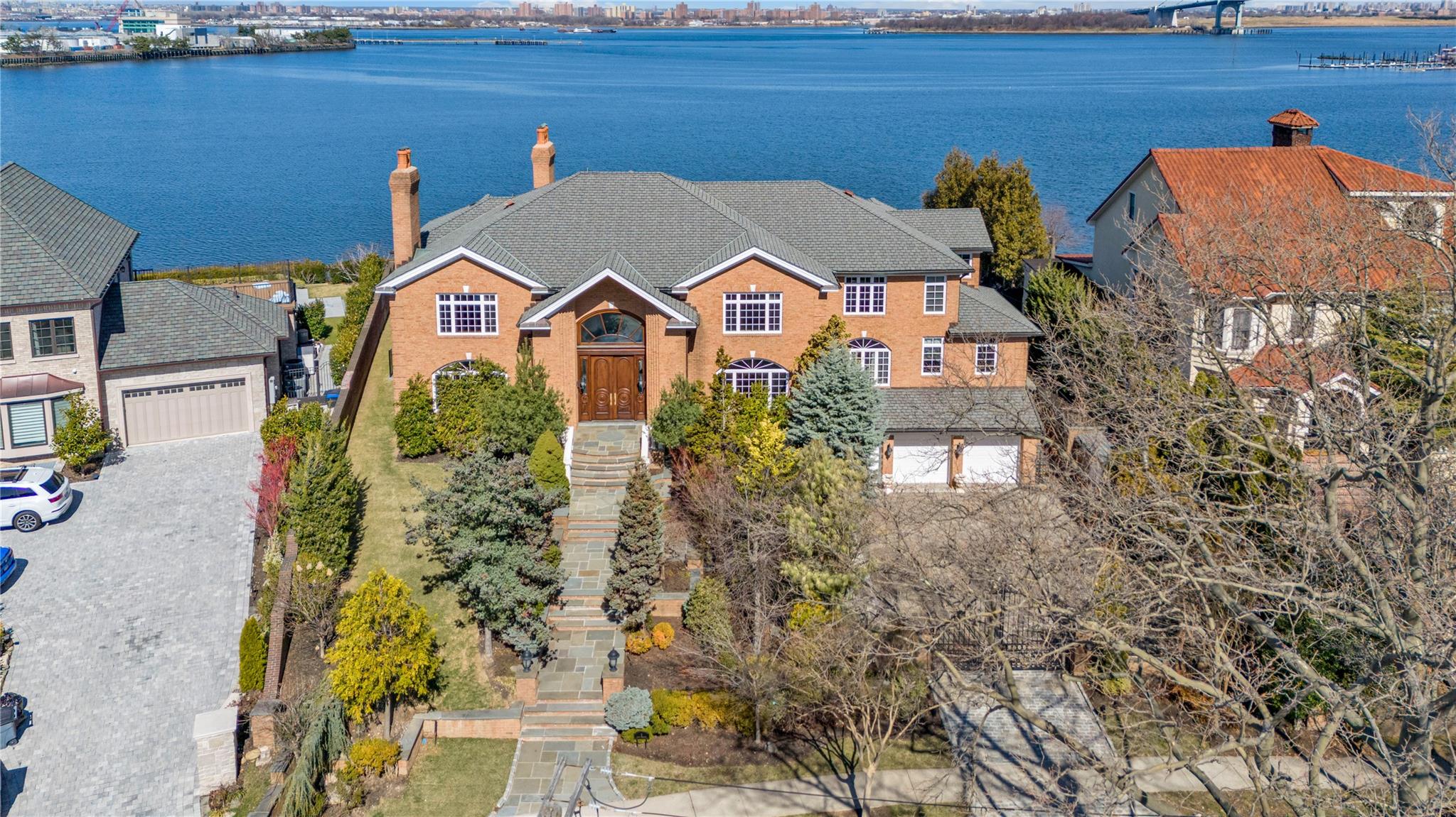 3 Point Crescent Queens, NY 11357 - Photo 35 of 38 View of front of house with a water view, a chimney, and a garage