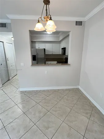a view of a livingroom with an empty space and a chandelier fan