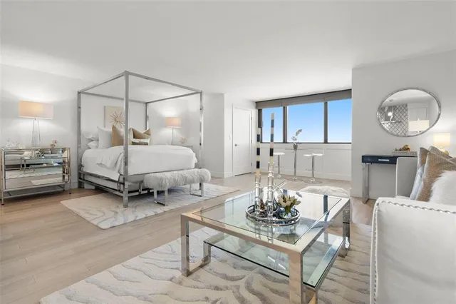 a living room with furniture and a lamp