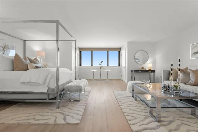 a bedroom with a bed and a lamp