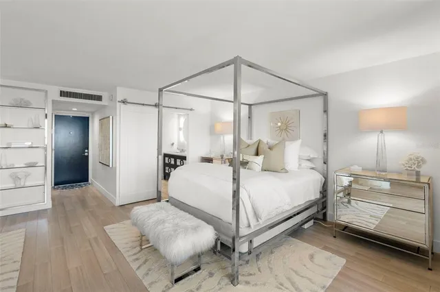 a bedroom with a bed and a chandelier