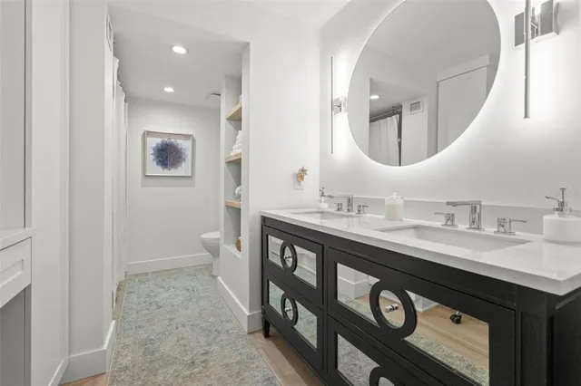 a view of room with a fan and hardwood floor