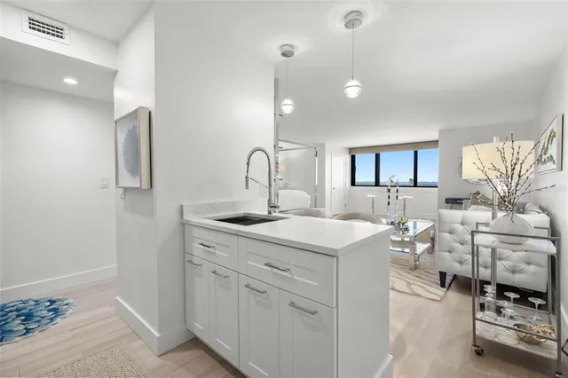 a kitchen with sink refrigerator and stove