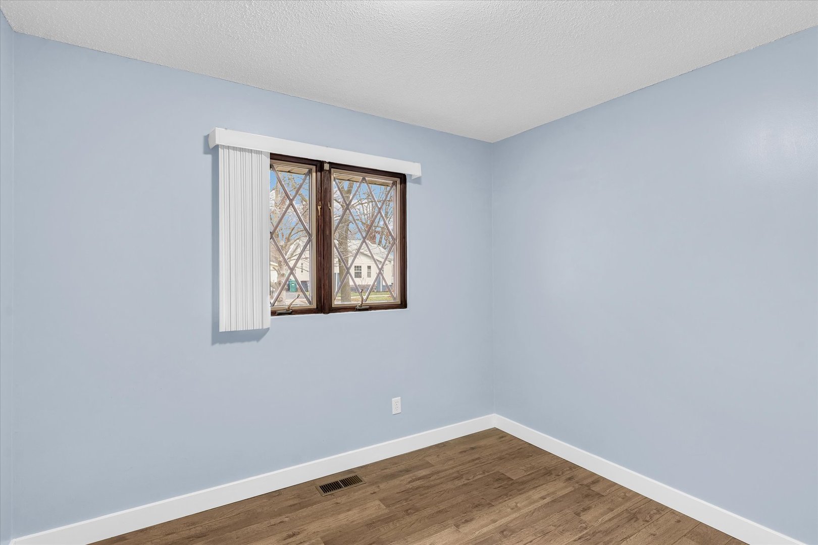 945 North Oakland Avenue Decatur, IL 62522 - Photo 22 of 49 a view of an empty room with wooden floor and a window