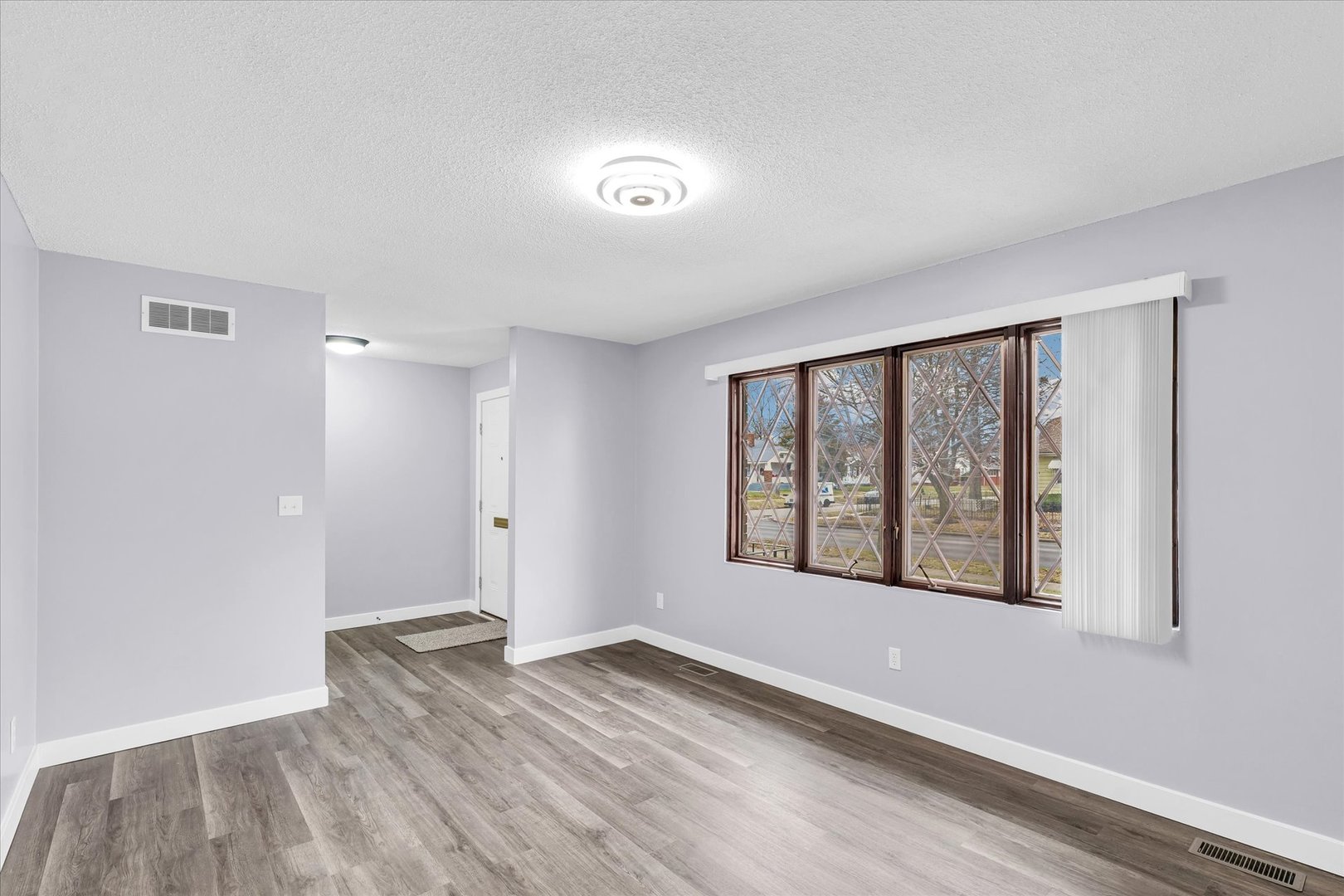 945 North Oakland Avenue Decatur, IL 62522 - Photo 8 of 49 a view of an empty room with wooden floor and a window