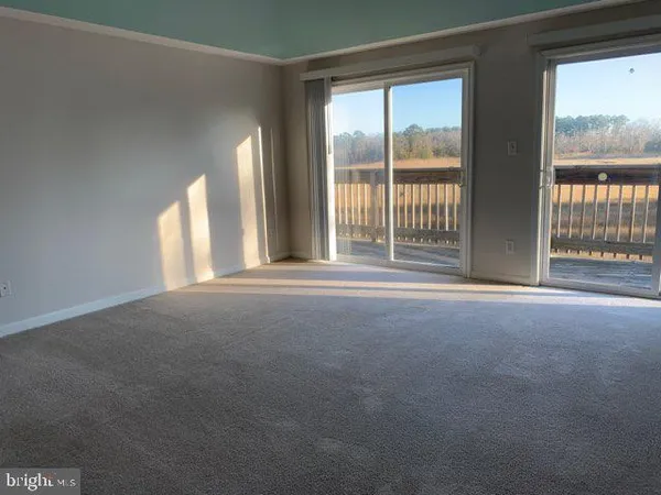 a view of empty room with floor to ceiling window