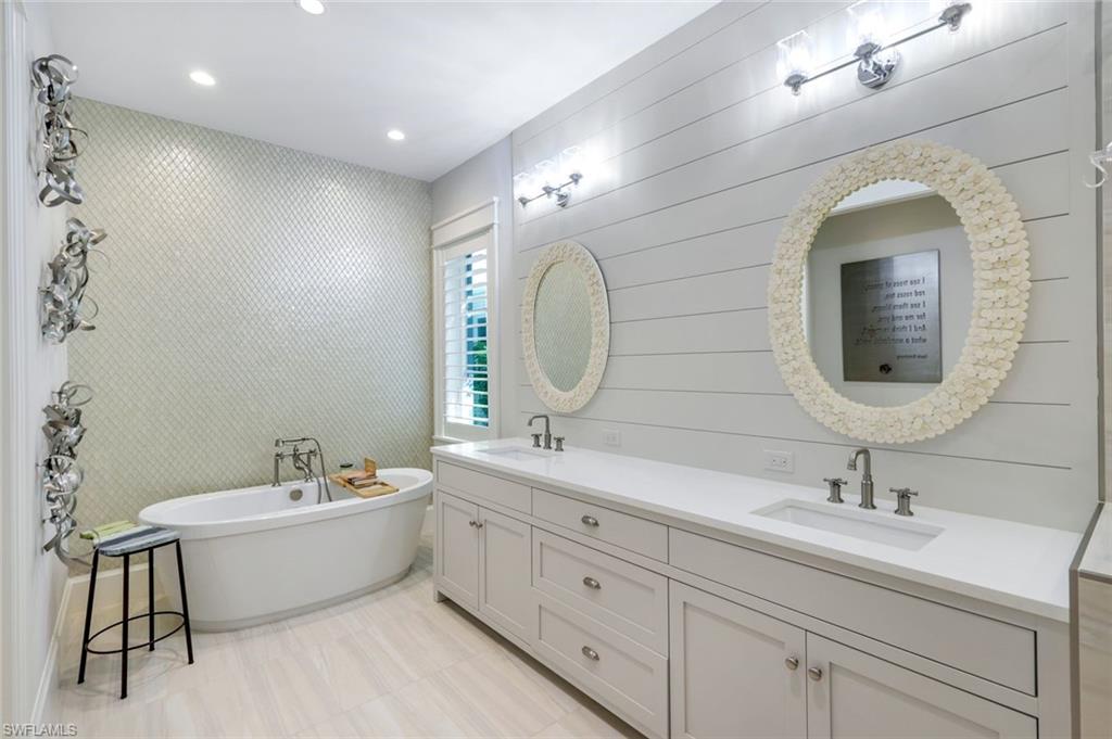 1463 2nd Avenue South Naples, FL 34102 - Photo 15 of 43 a bathroom with a double vanity sink mirror and bathtub