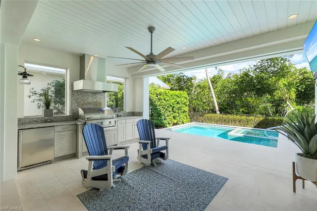 a work room with furniture and large windows