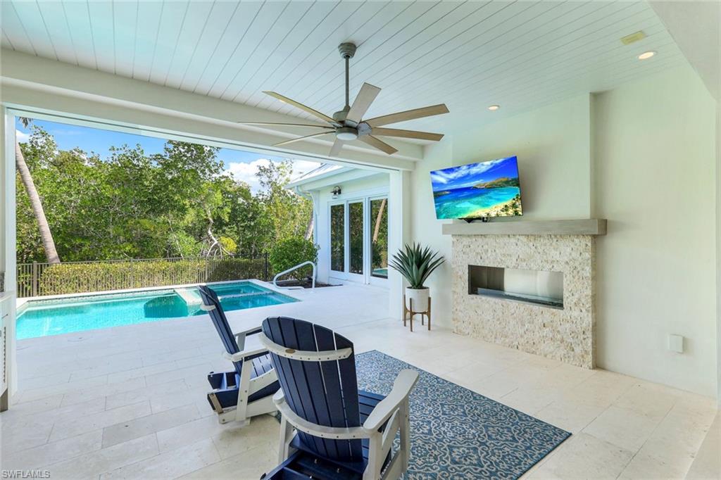 1463 2nd Avenue South Naples, FL 34102 - Photo 22 of 43 a living room with furniture and a fireplace
