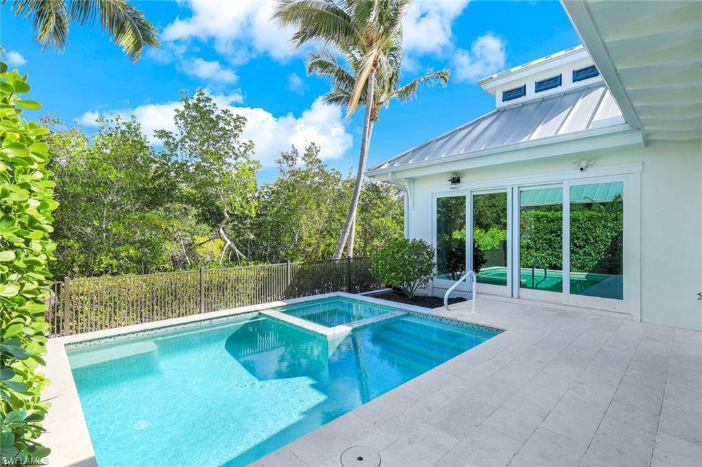 1463 2nd Avenue South Naples, FL 34102 - Photo 23 of 43 a view of a swimming pool with an outdoor seating