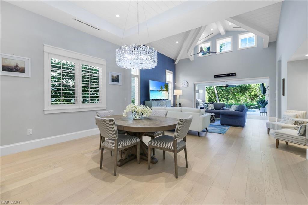 1463 2nd Avenue South Naples, FL 34102 - Photo 5 of 43 a view of a dining room with furniture a chandelier and wooden floor
