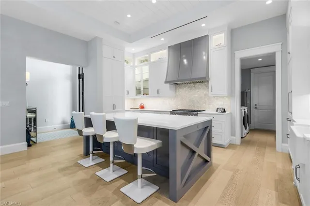 a bathroom with a double vanity sink mirror and bathtub