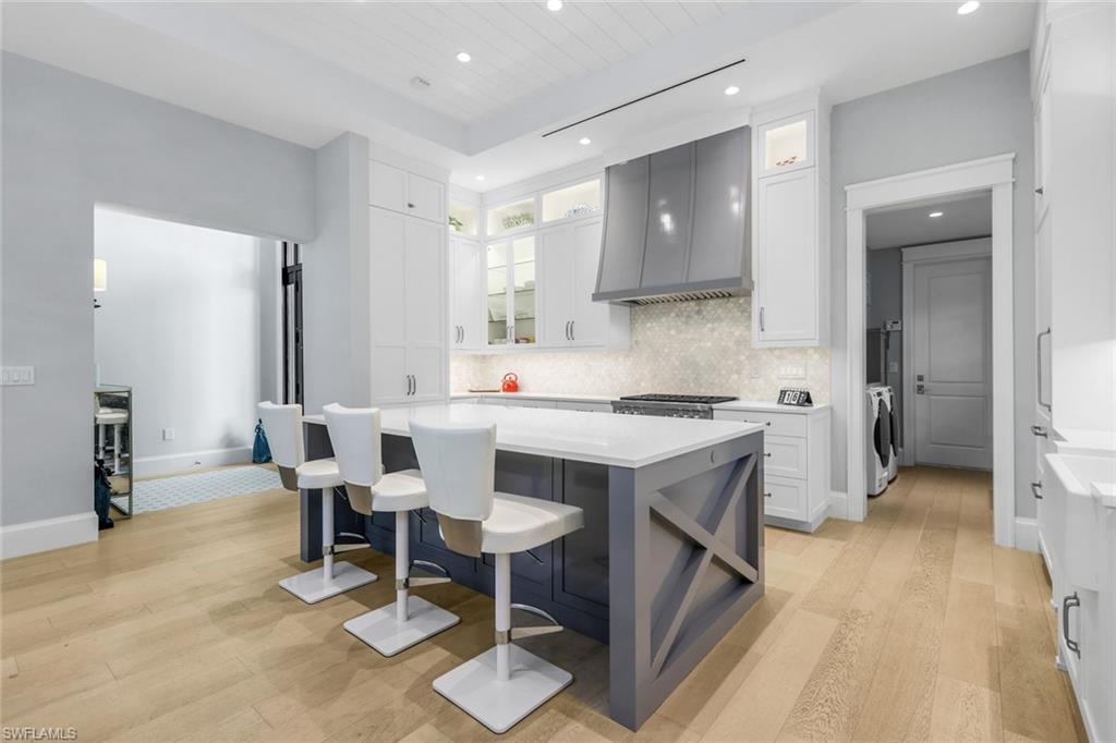 1463 2nd Avenue South Naples, FL 34102 - Photo 8 of 43 a kitchen with a sink cabinets and wooden floor