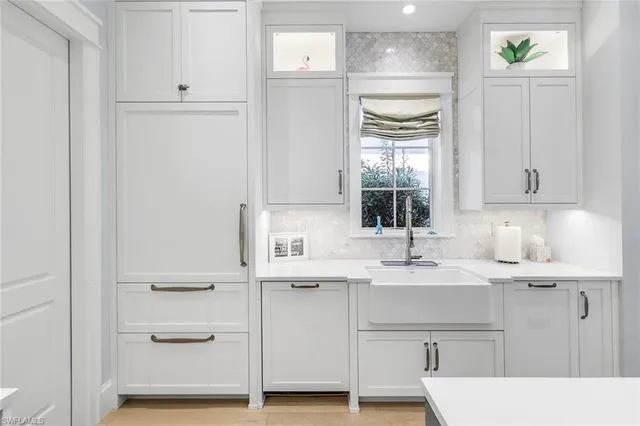 a bathroom with a double vanity sink mirror and bathtub