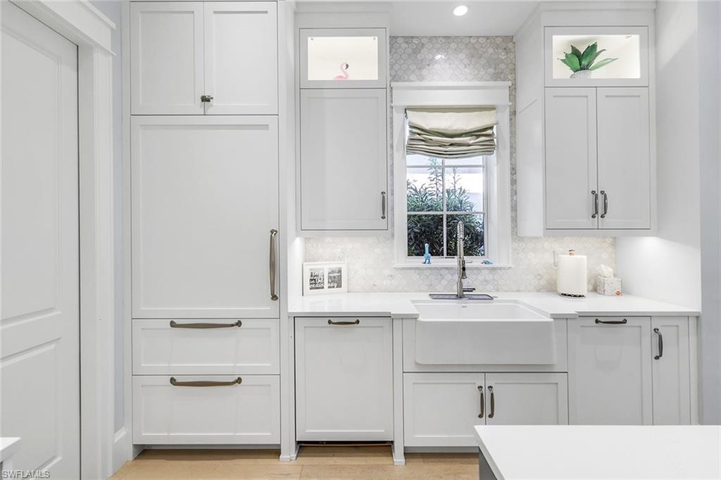 1463 2nd Avenue South Naples, FL 34102 - Photo 9 of 43 a bathroom with a sink a mirror and a window