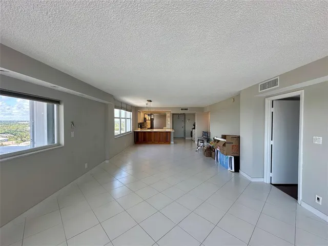 a bathroom with a granite countertop sink toilet a mirror and bathtub