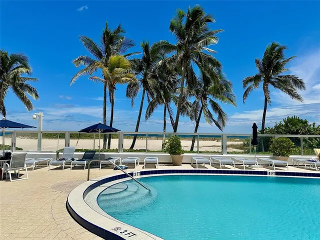 a swimming pool with outdoor seating