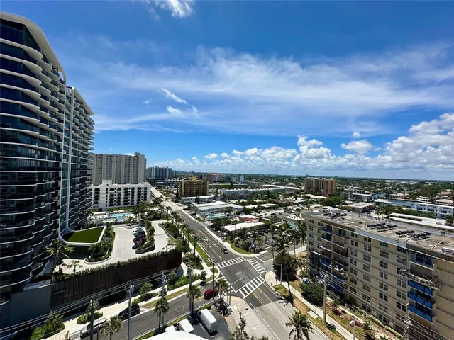 a large kitchen with stainless steel appliances kitchen island granite countertop a refrigerator and a stove top oven
