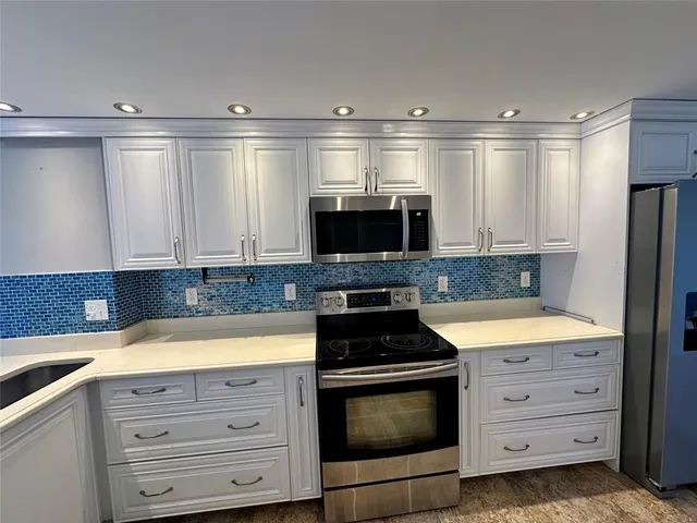 a view of a kitchen with a washer and dryer
