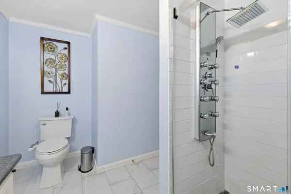 a white toilet sitting next to a bathroom sink