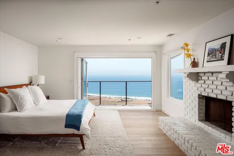 a bedroom with a bed and a fireplace