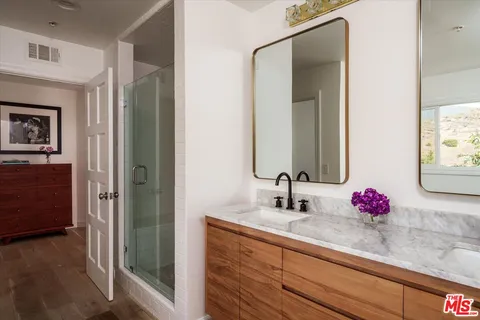 a bathroom with a sink vanity and mirror
