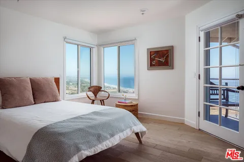 a bedroom with a bed and a book shelf