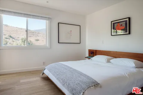 a bathroom with a granite countertop sink toilet and mirror