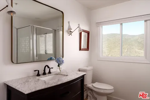 a bedroom with a large bed and a large window