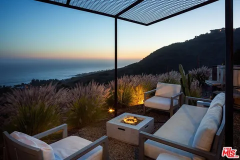 a view of roof deck with chair and table