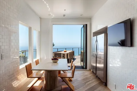 a view of a dining room with furniture and a table