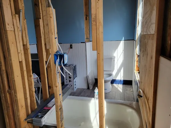 a utility room with closet and mirror