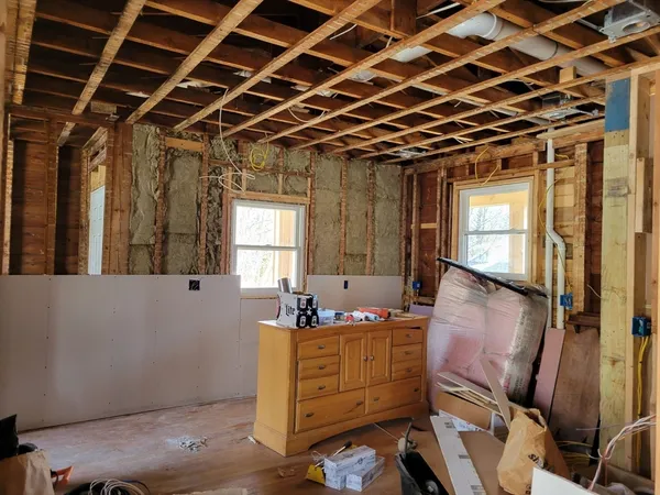 a bathroom with a tub sink and mirror