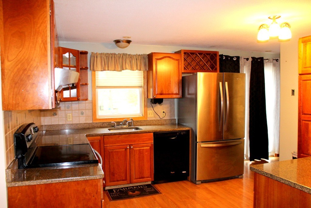 8 Kingsbury Road Webster, MA 01570 - Photo 3 of 29 a kitchen with a refrigerator and a sink
