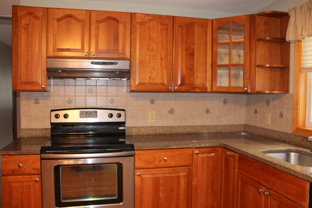 8 Kingsbury Road Webster, MA 01570 - Photo 8 of 29 a kitchen with granite countertop wood cabinets stainless steel appliances and a sink