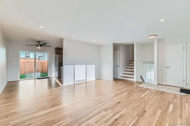 a view of an empty room with wooden floor
