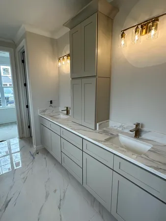 a room with a sink and mirror