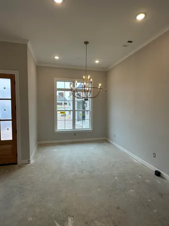 a large kitchen with a large counter top space a sink stainless steel appliances and cabinets