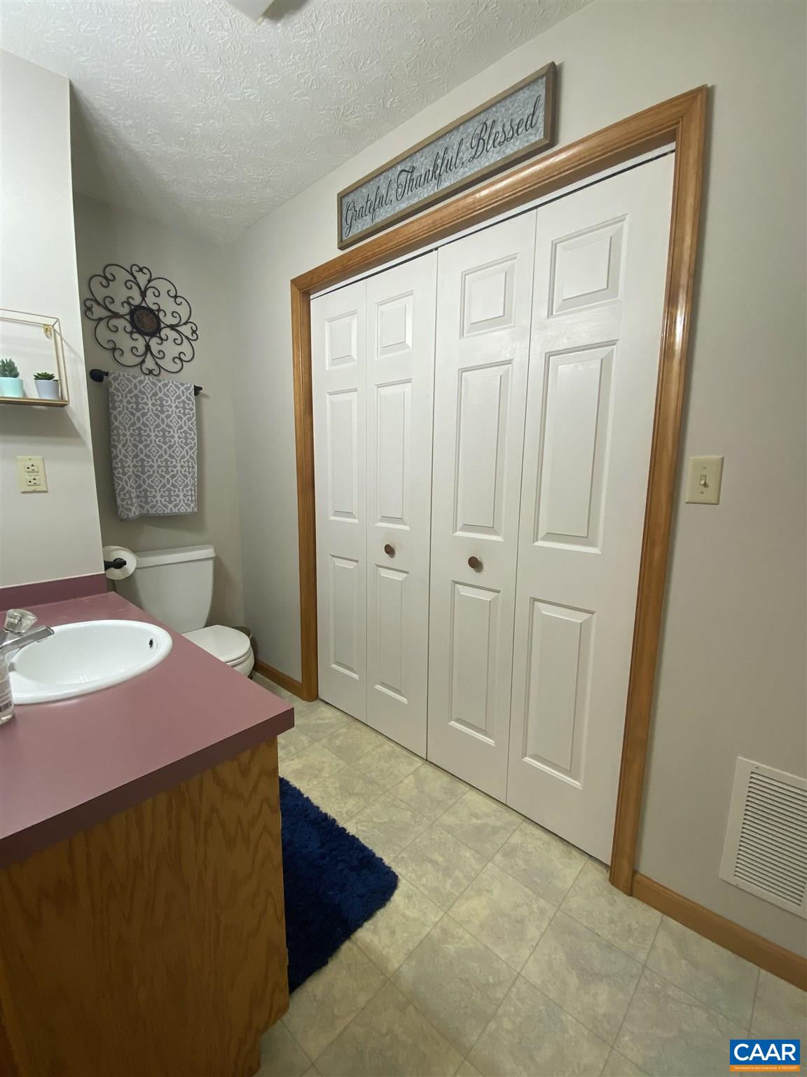 11 Stonefield Road Palmyra, VA 22963 - Photo 13 of 27 a spacious bedroom with a bed and a table