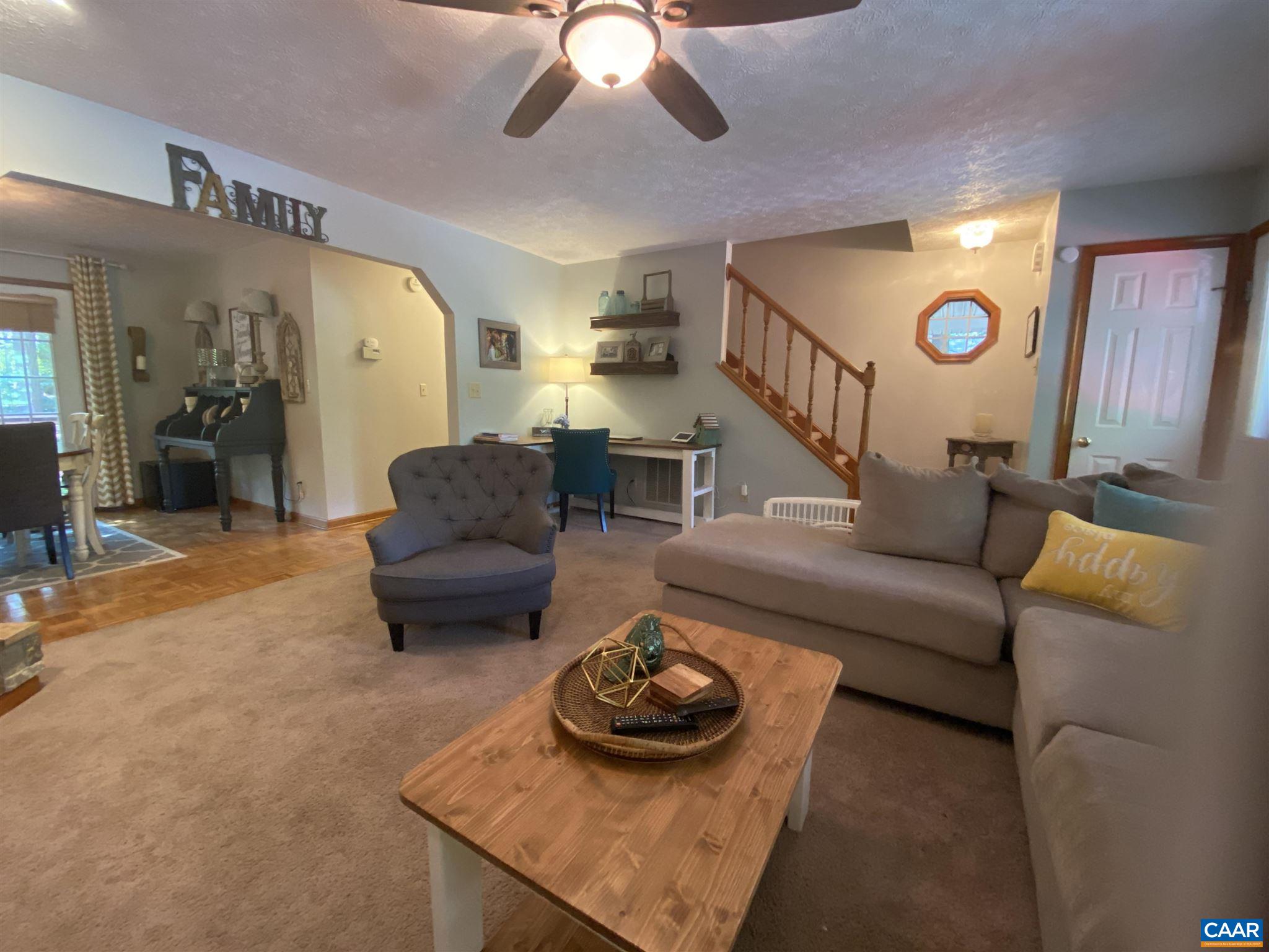 11 Stonefield Road Palmyra, VA 22963 - Photo 6 of 27 a living room with furniture and a chandelier