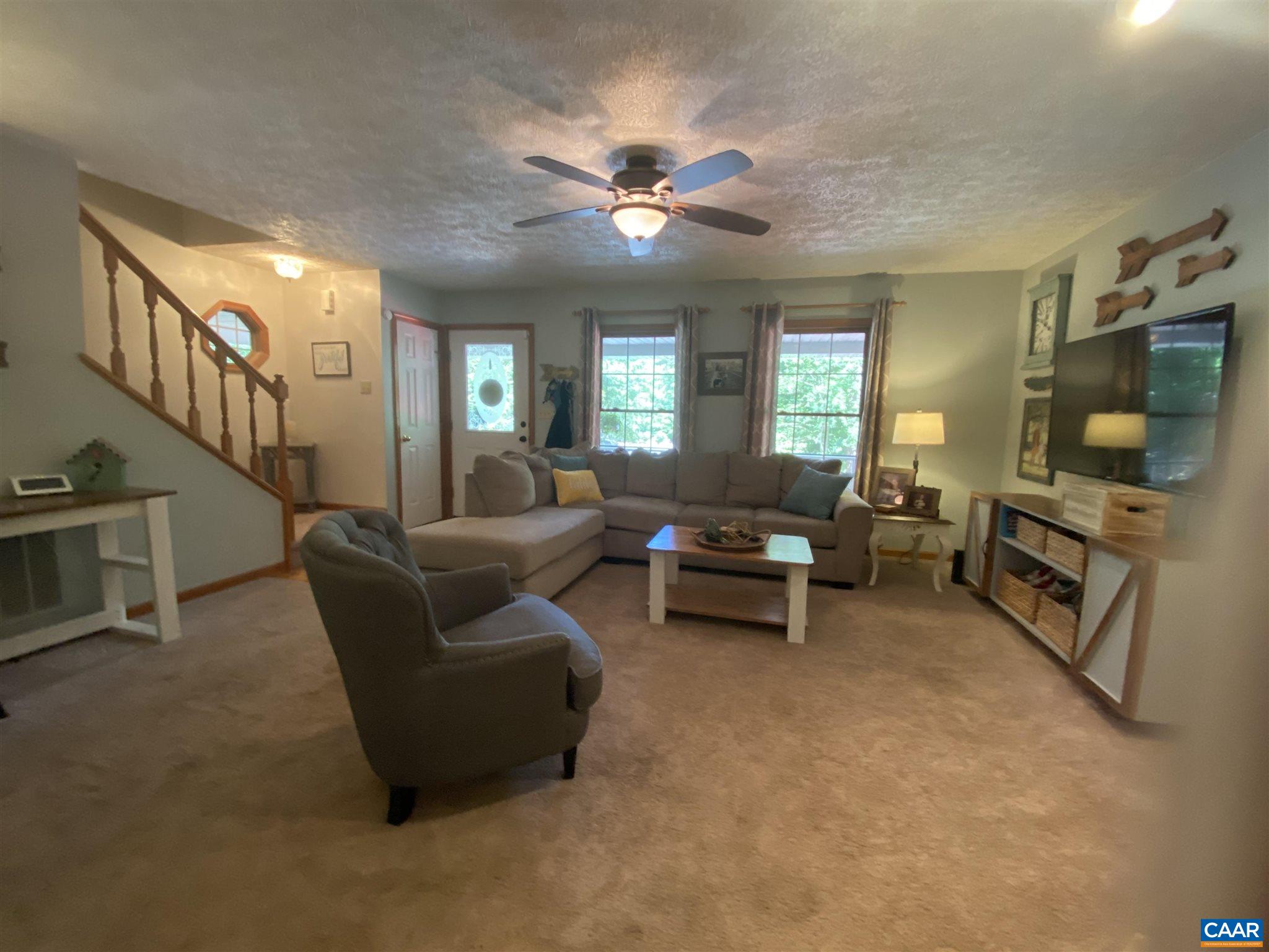 11 Stonefield Road Palmyra, VA 22963 - Photo 7 of 27 a living room with furniture and a flat screen tv