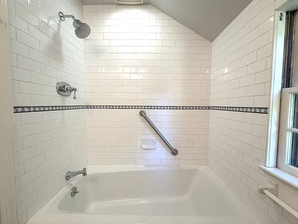 a bathroom with a bathtub and shower