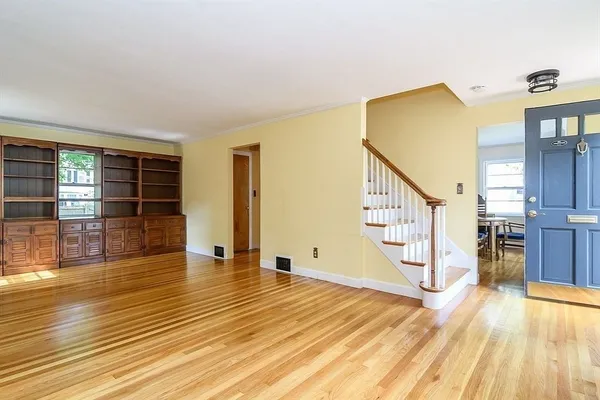 a view of empty room with wooden floor