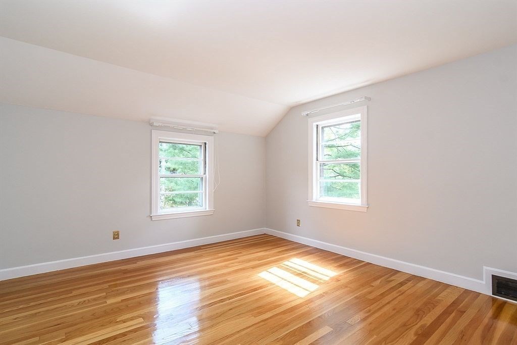 115 Parker Road Wellesley, MA 02482 - Photo 10 of 21 an empty room with wooden floor and windows