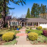 a view of a house with backyard and sitting area