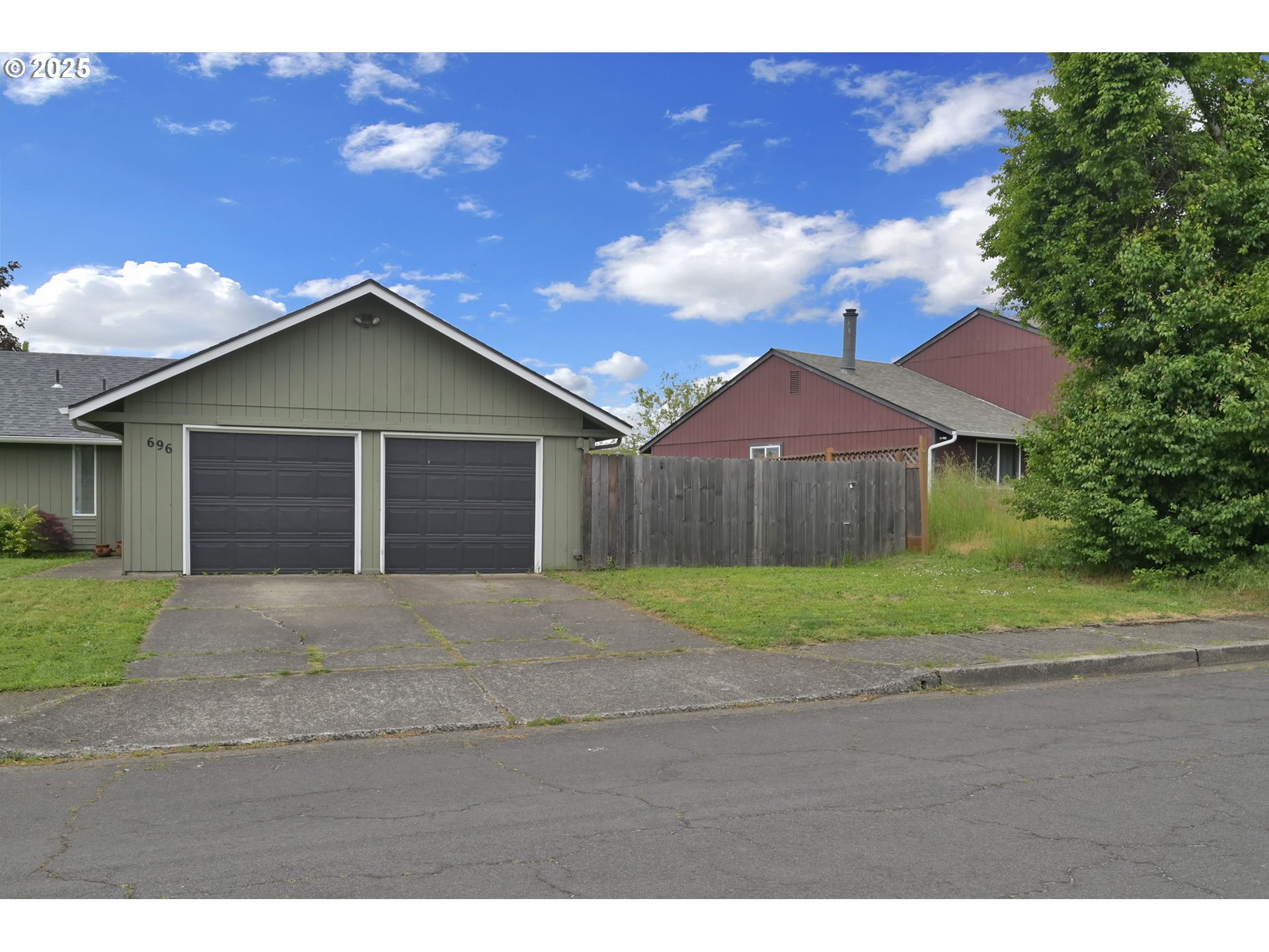 696 Island Street Springfield, OR 97477 - Photo 20 of 27 a front view of a house with a yard and garage