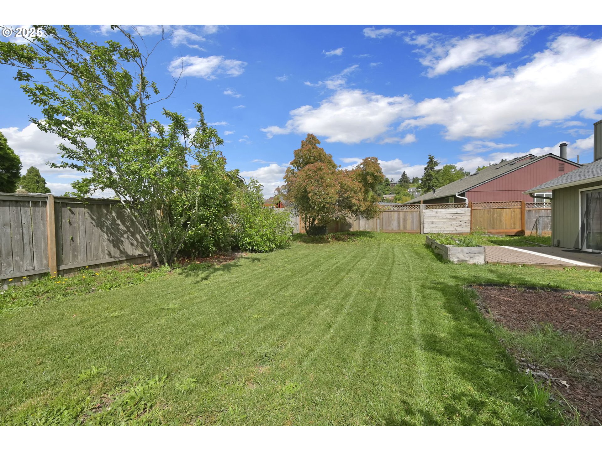 696 Island Street Springfield, OR 97477 - Photo 21 of 27 a view of a backyard with a garden