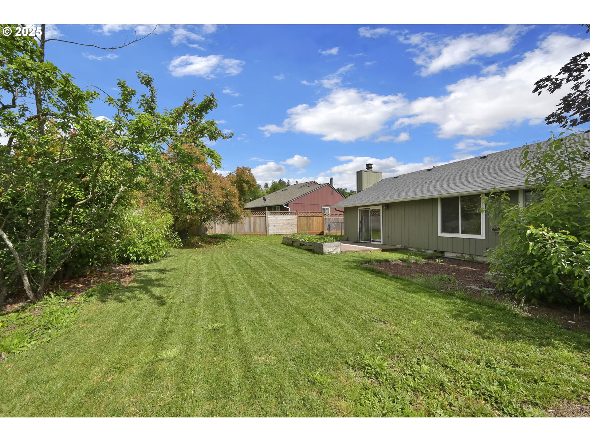 696 Island Street Springfield, OR 97477 - Photo 25 of 27 a view of a house with a backyard